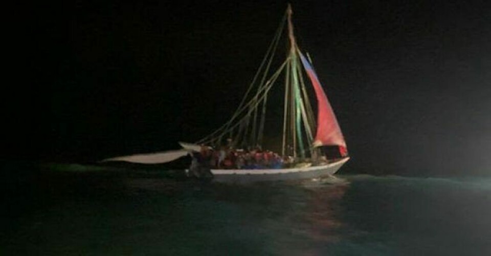 Photo- (U.S. Coast Guard) An overloaded 60-foot Haitian sailing vessel approximately 25 miles northeast of Anguilla Cay, Bahamas